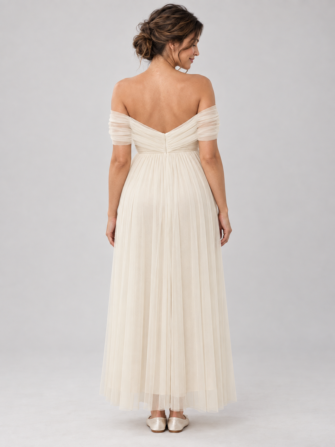 Back view of the Amelie dress with draped tulle, a shallow V-shaped back and an ankle-length hem.