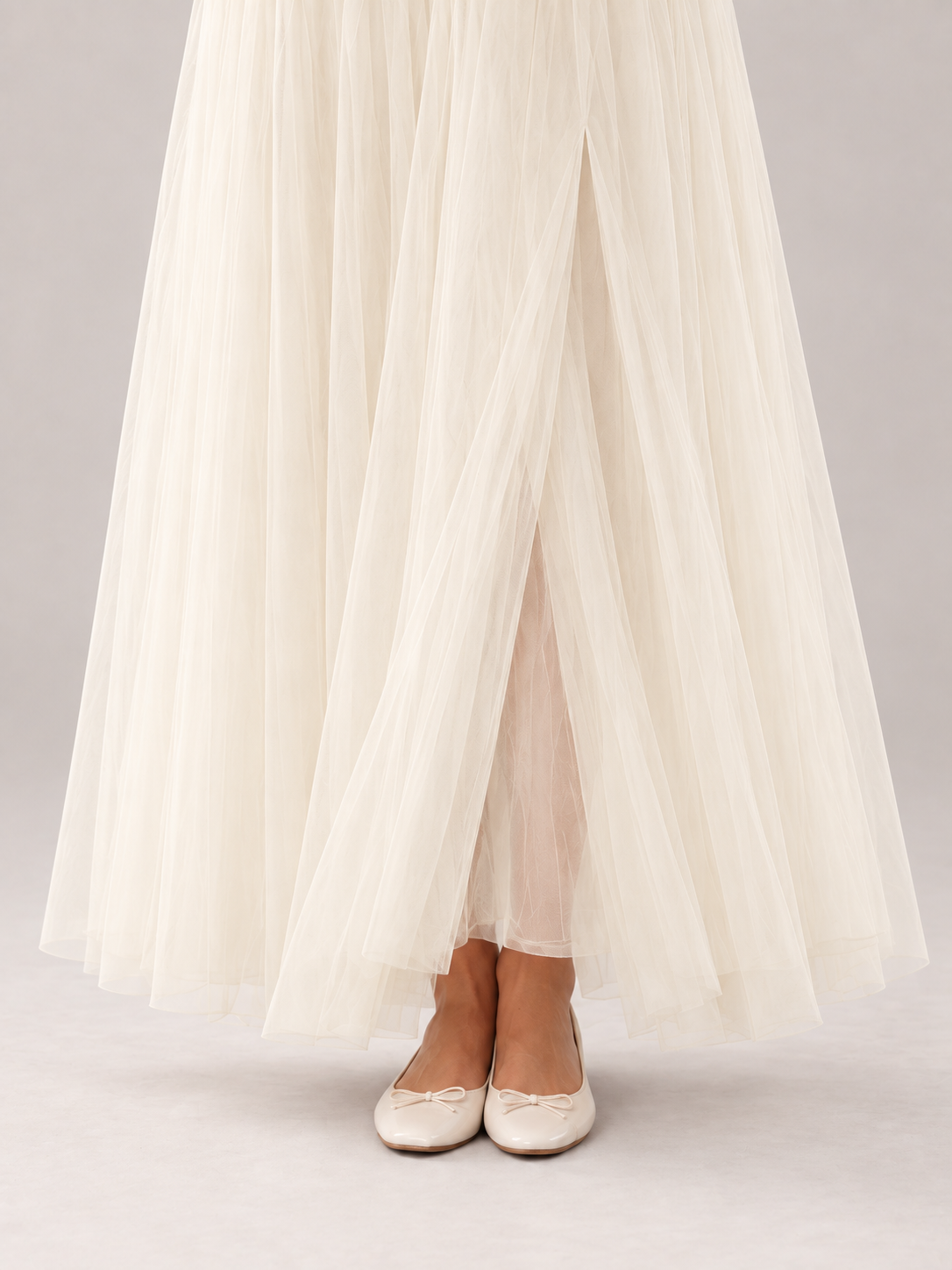 Layered tulle hem and lining of the apricot Amelie maternity dress.