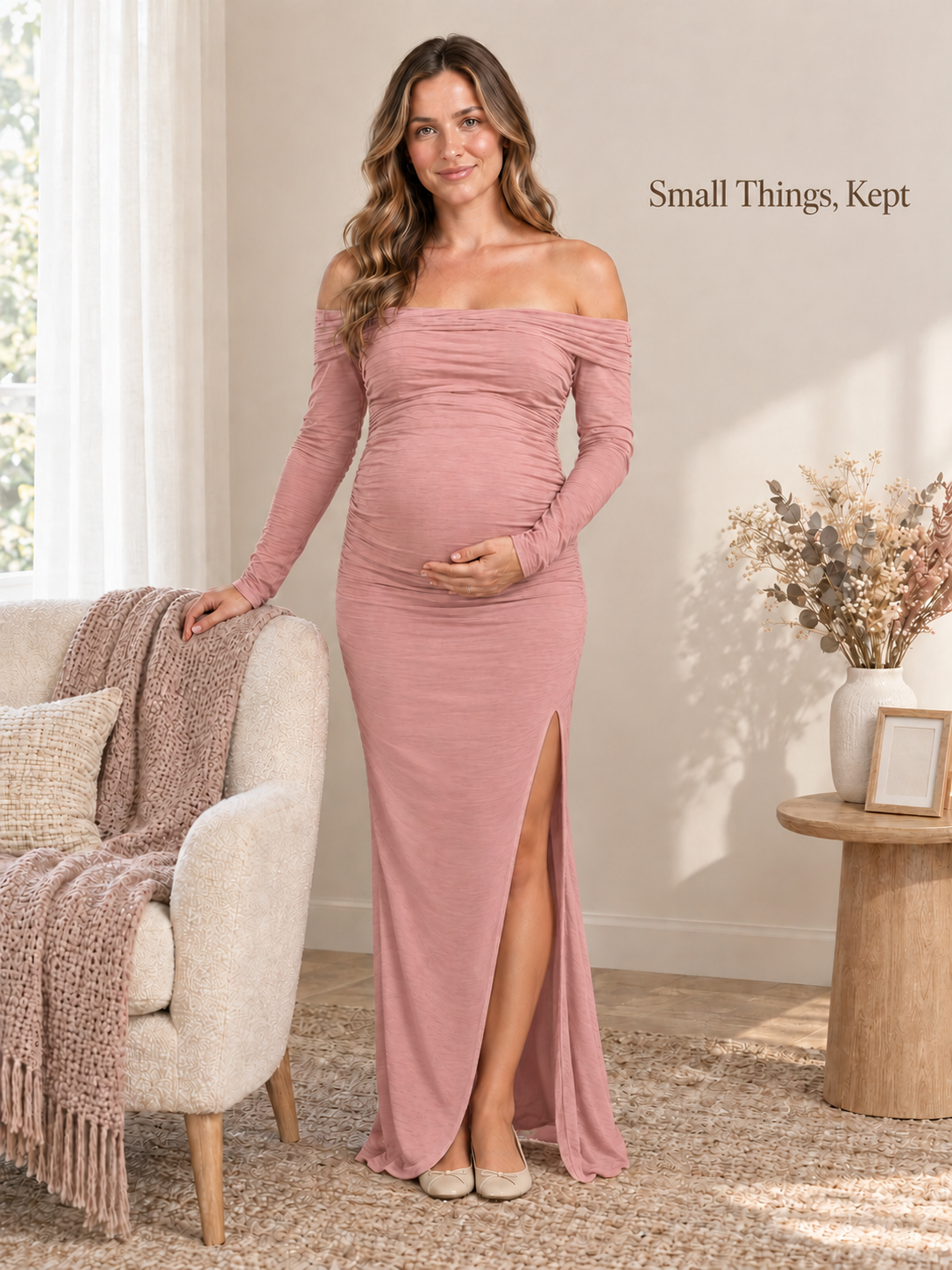 Imogen Mauve maternity dress — standing beside an armchair with a knitted throw