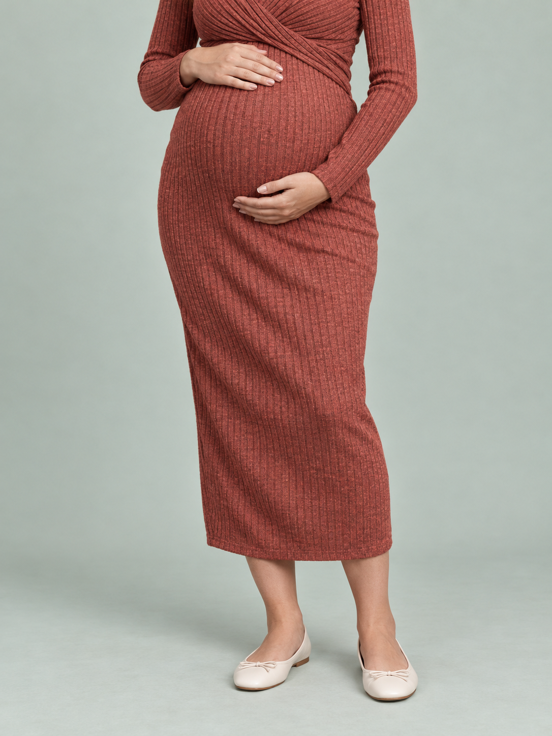 Maeve Rust Red maternity dress — close crop of the twist-front waist and skirt