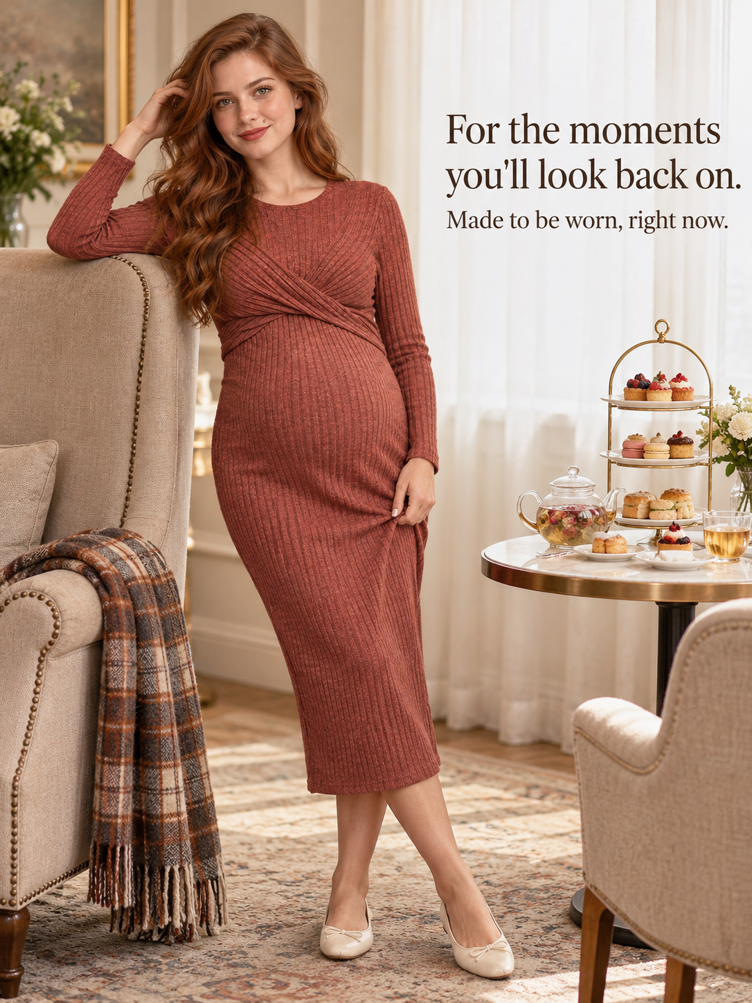 Maeve Rust Red maternity dress — resting against an armchair near a tea stand