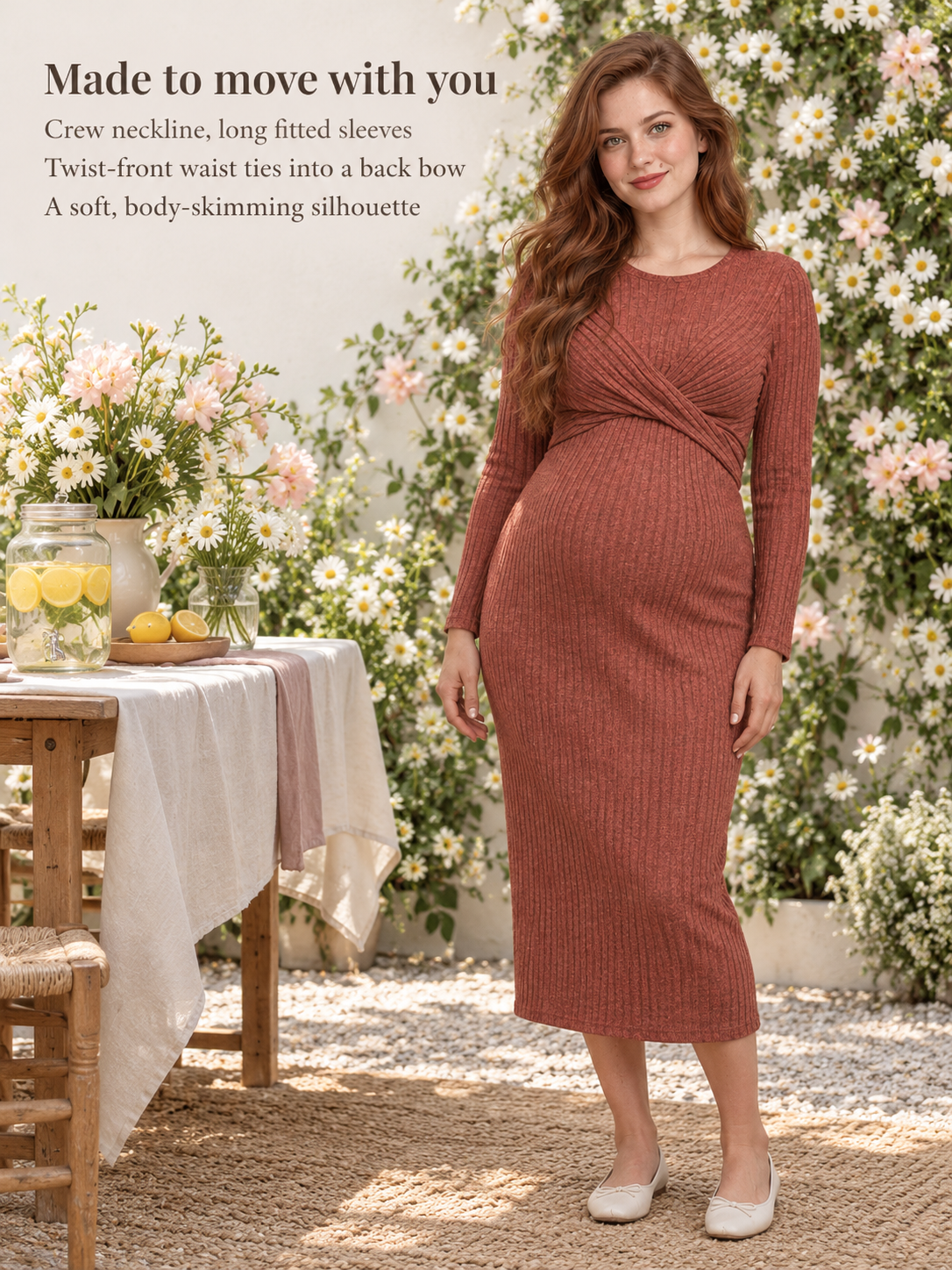 Maeve Rust Red maternity dress — standing at an outdoor table with flowers and lemons