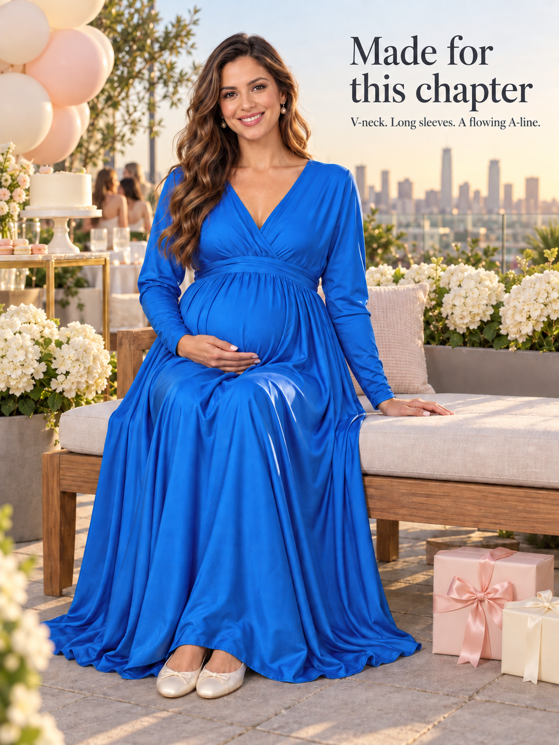 Nora Royal Blue maternity dress — seated on a terrace bench at a celebration