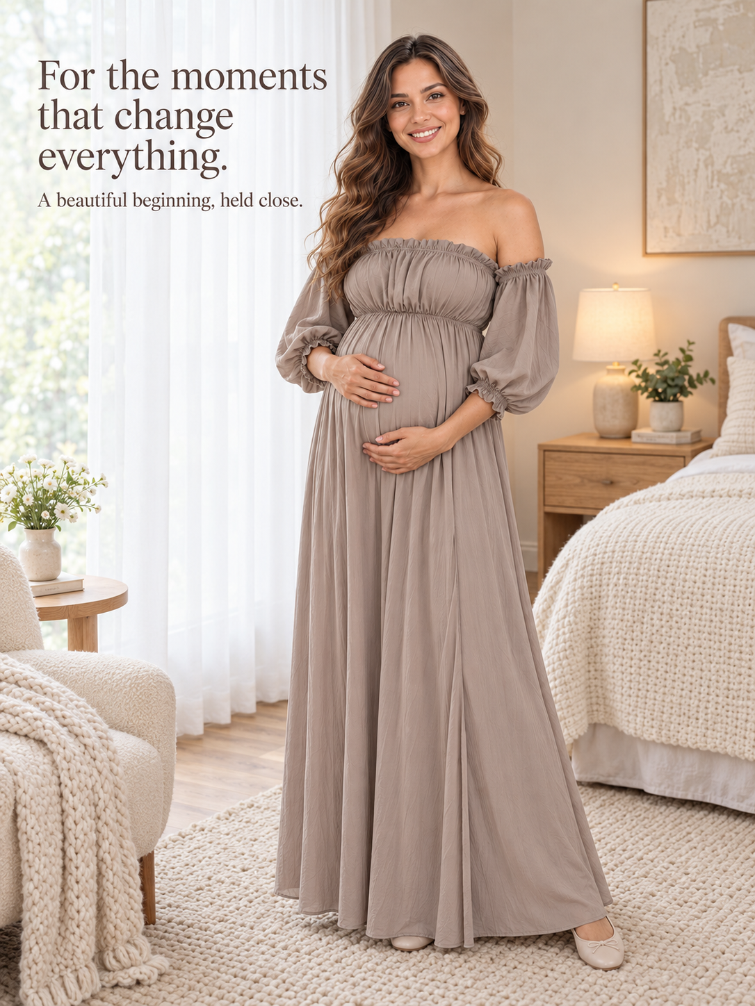 Elodie Taupe maternity dress — standing in a bright bedroom beside a knit throw
