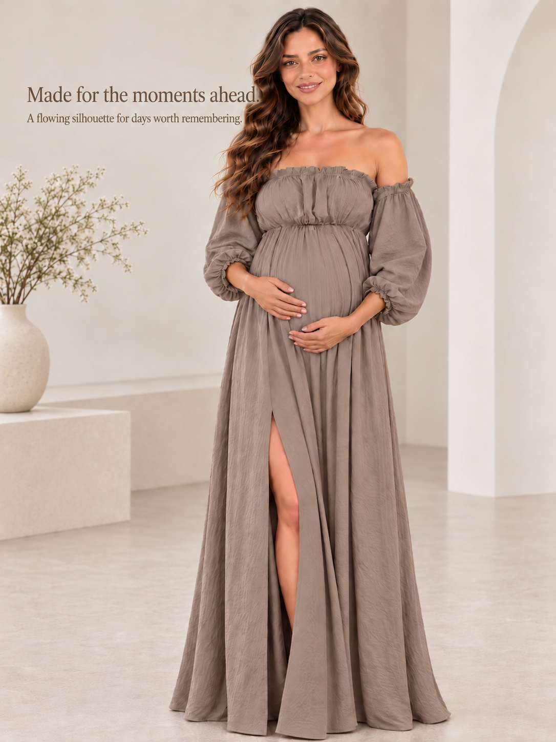 Elodie Taupe maternity dress — full-length view showing the high front slit in a bright room