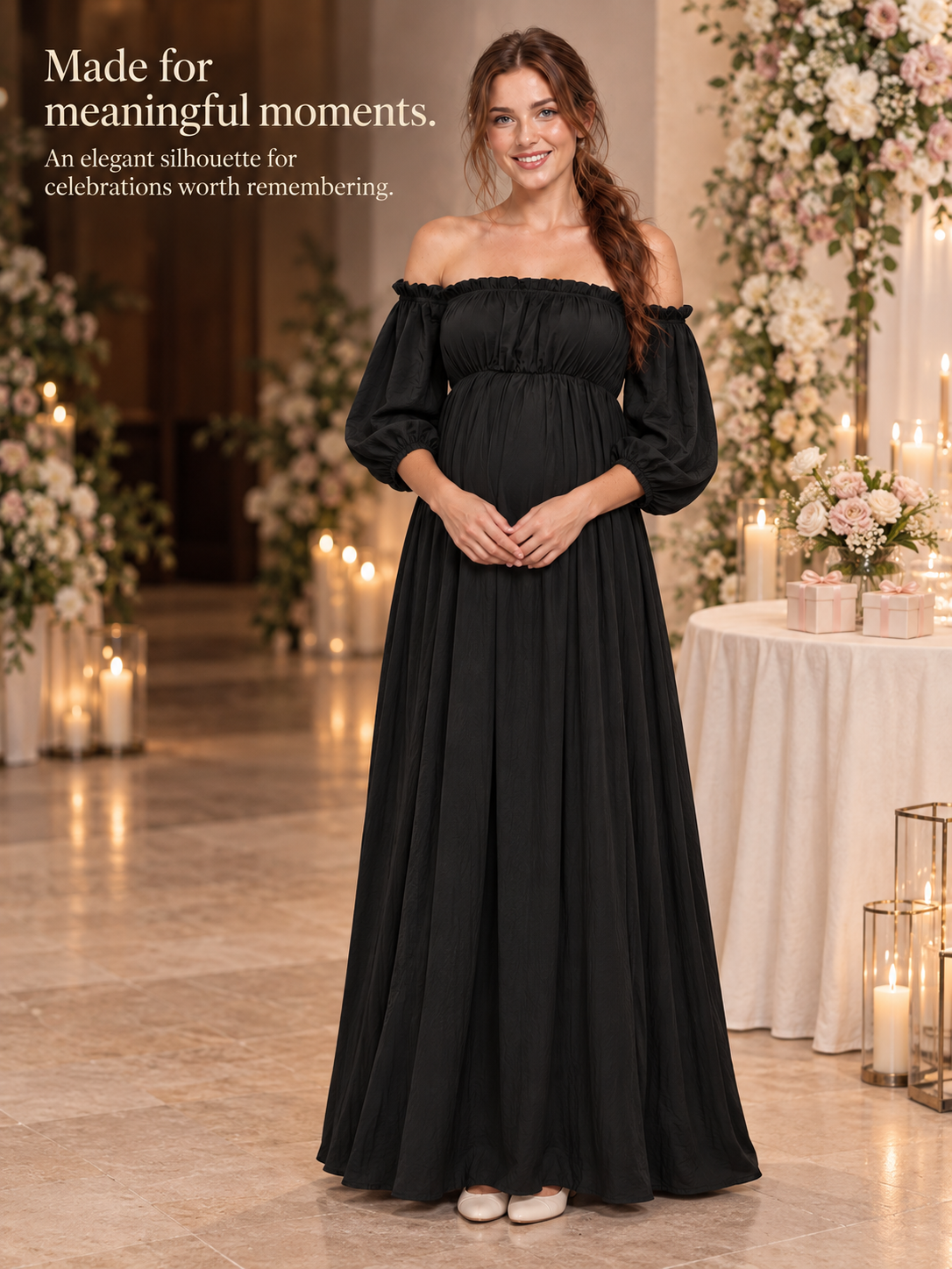 Elodie Black maternity dress — standing in a candlelit room beside a gift table