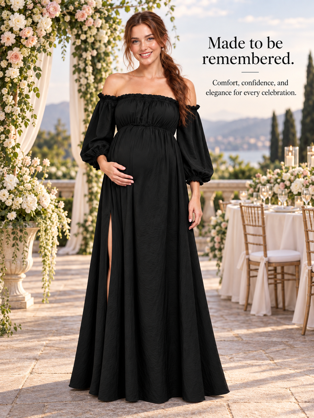 Elodie Black maternity dress — full-length view on a terrace overlooking the water