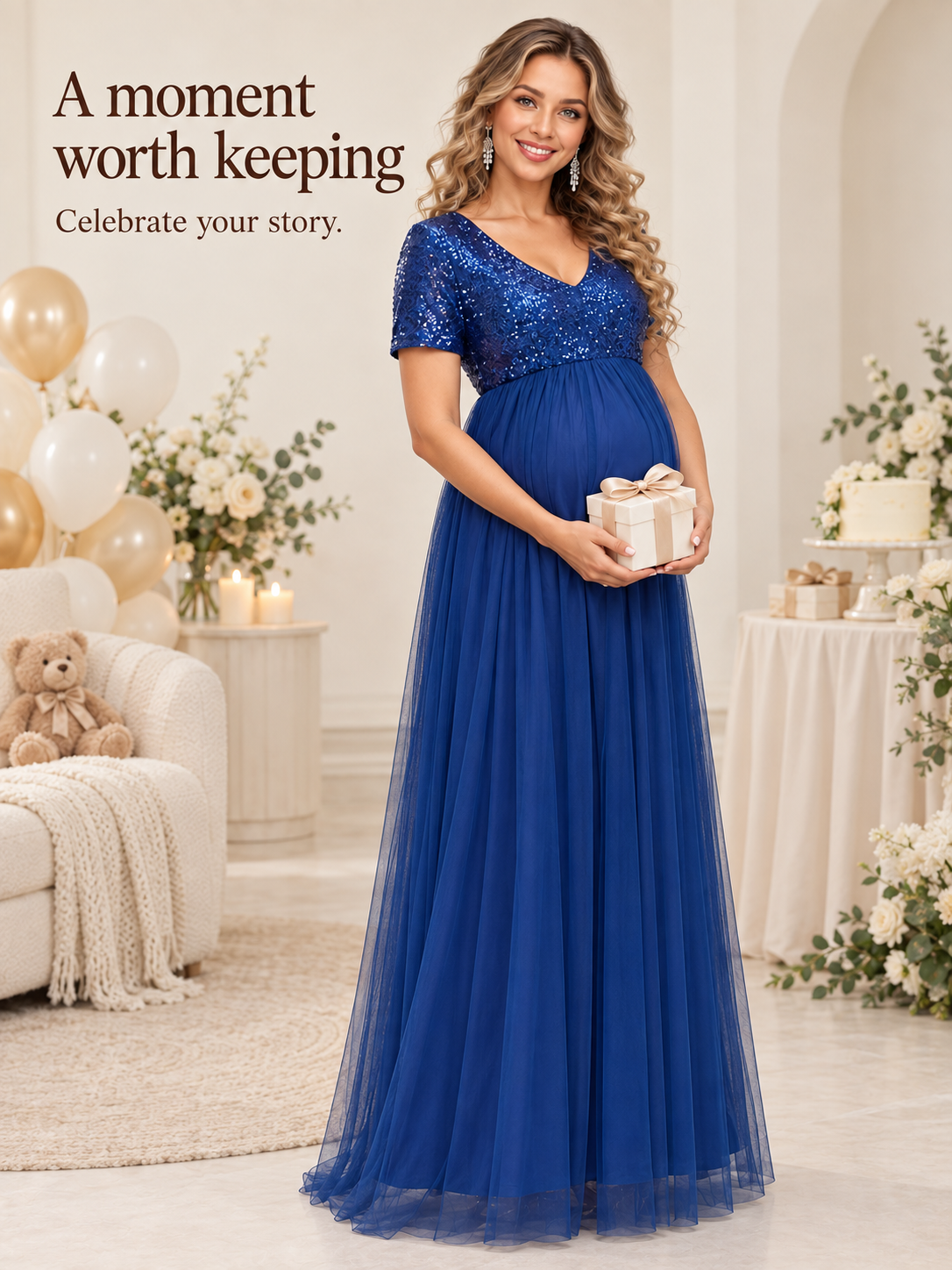 Celestine Royal Blue maternity dress — full-length portrait holding a gift box beside balloons and a cake