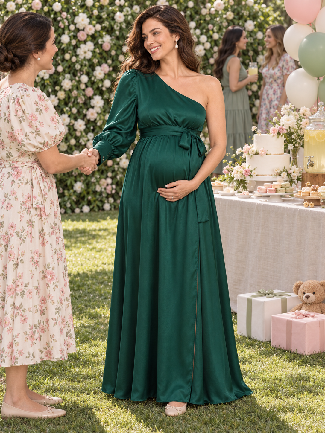 Sylvie Emerald Green maternity dress — greeting a guest with a handshake on the lawn