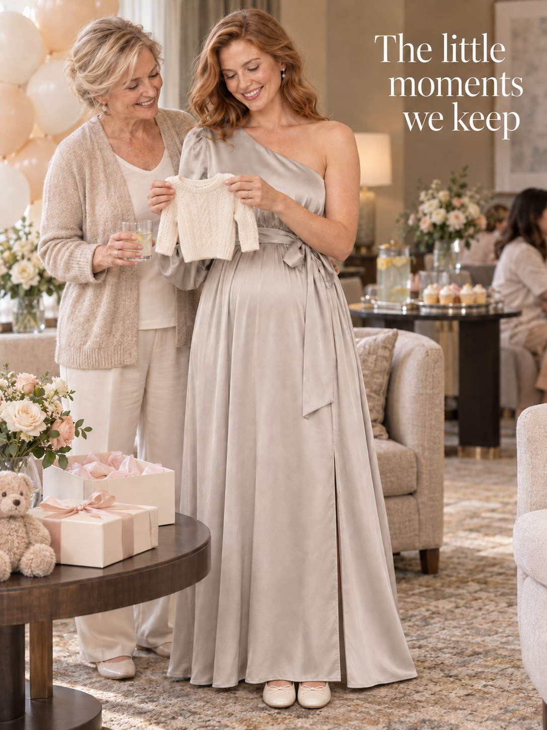 Sylvie Dove Gray maternity dress — admiring a tiny knit baby sweater with a loved one