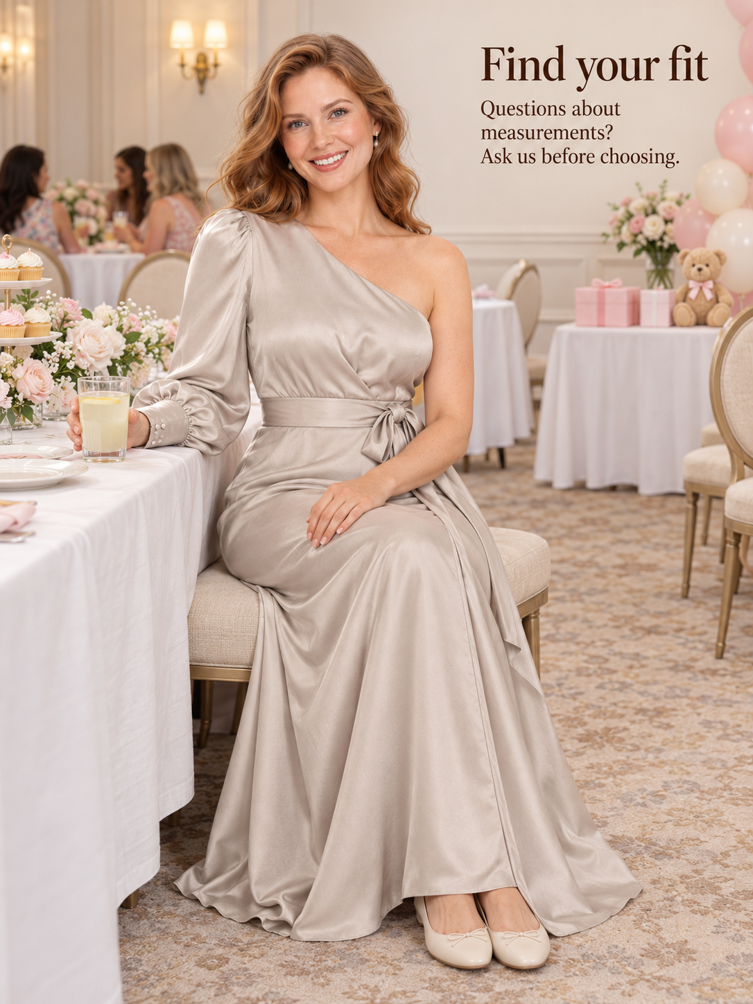 Sylvie Dove Gray maternity dress — seated at a celebration table holding a glass of lemonade