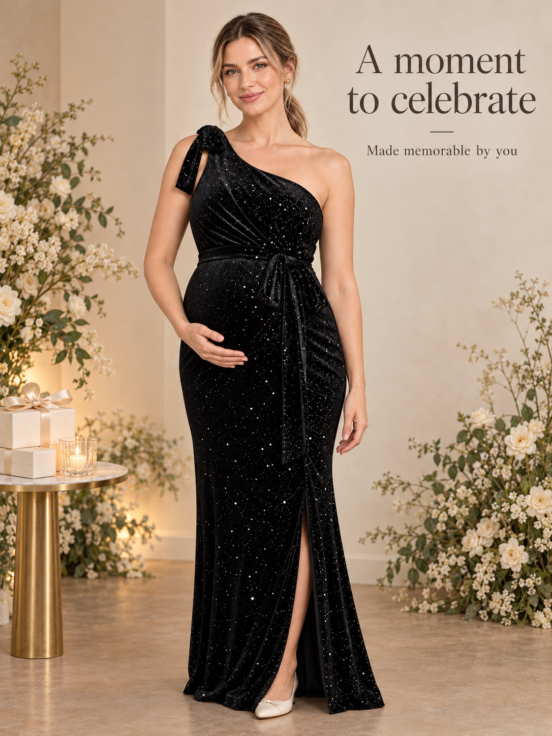 Ines Black maternity dress — standing among flowers beside a small gift table