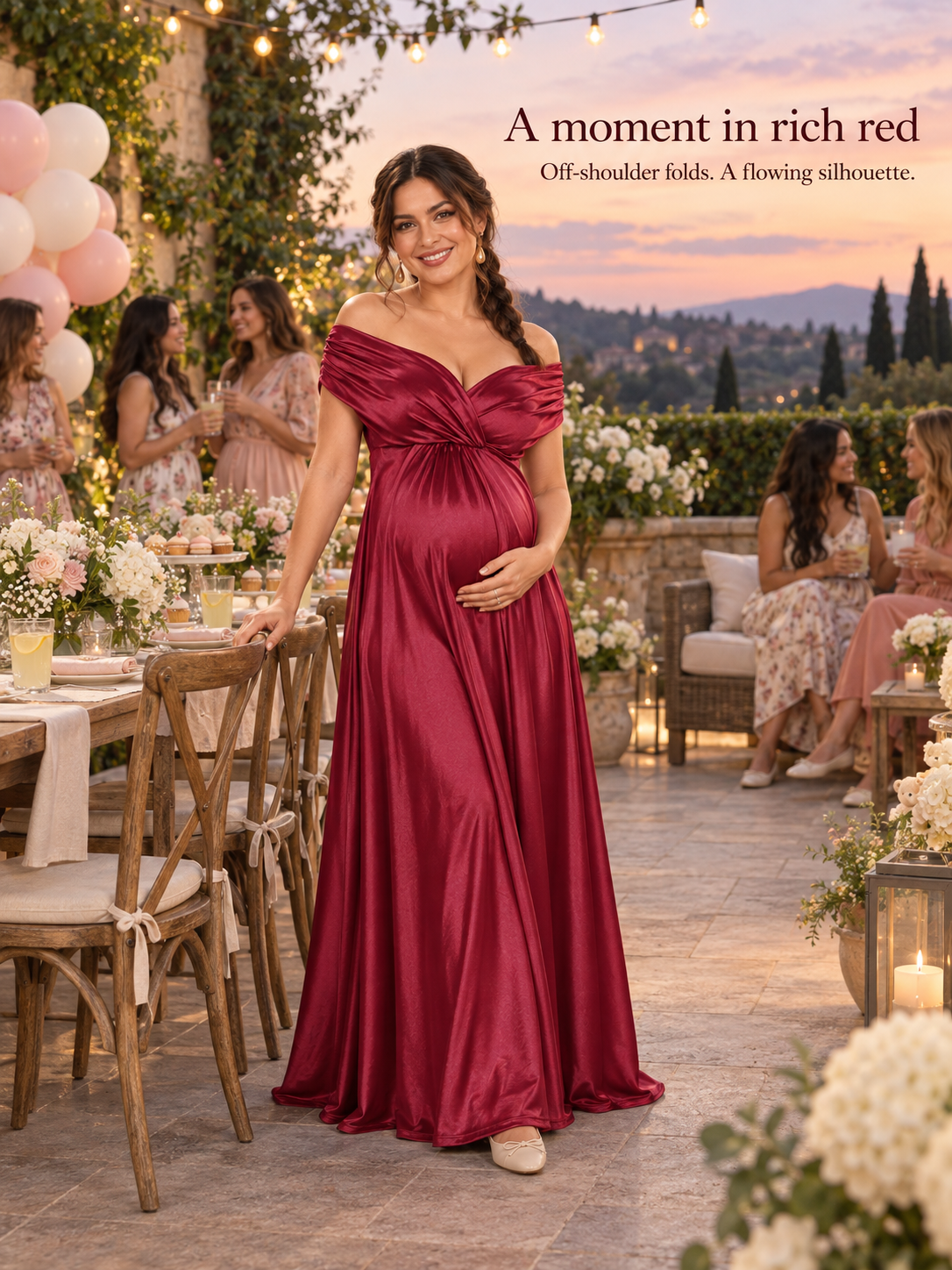 Cressida Wine Red maternity dress — full-length view on a terrace at a sunset baby shower