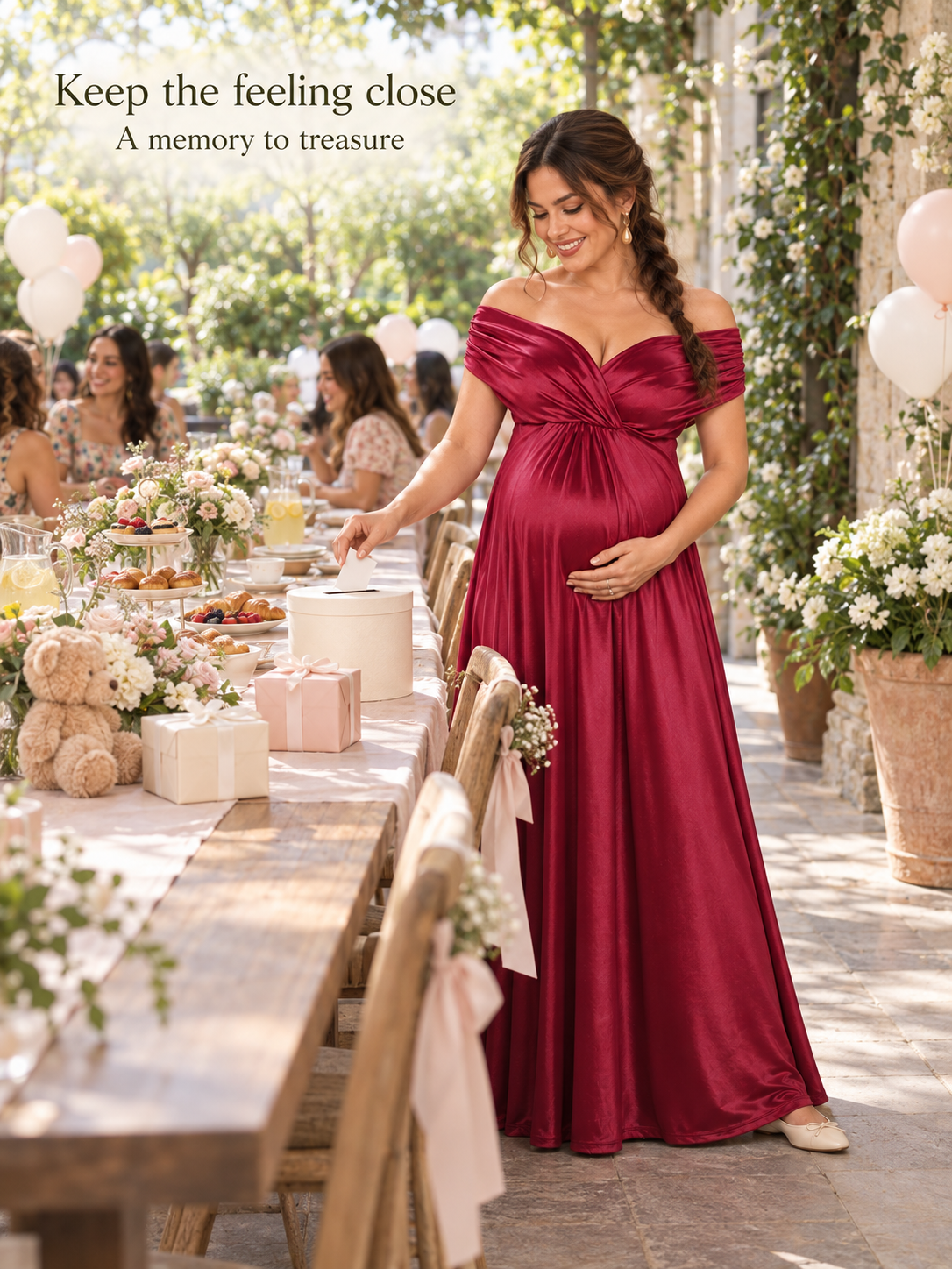 Cressida Wine Red maternity dress — dropping a card into a box at a garden gift table