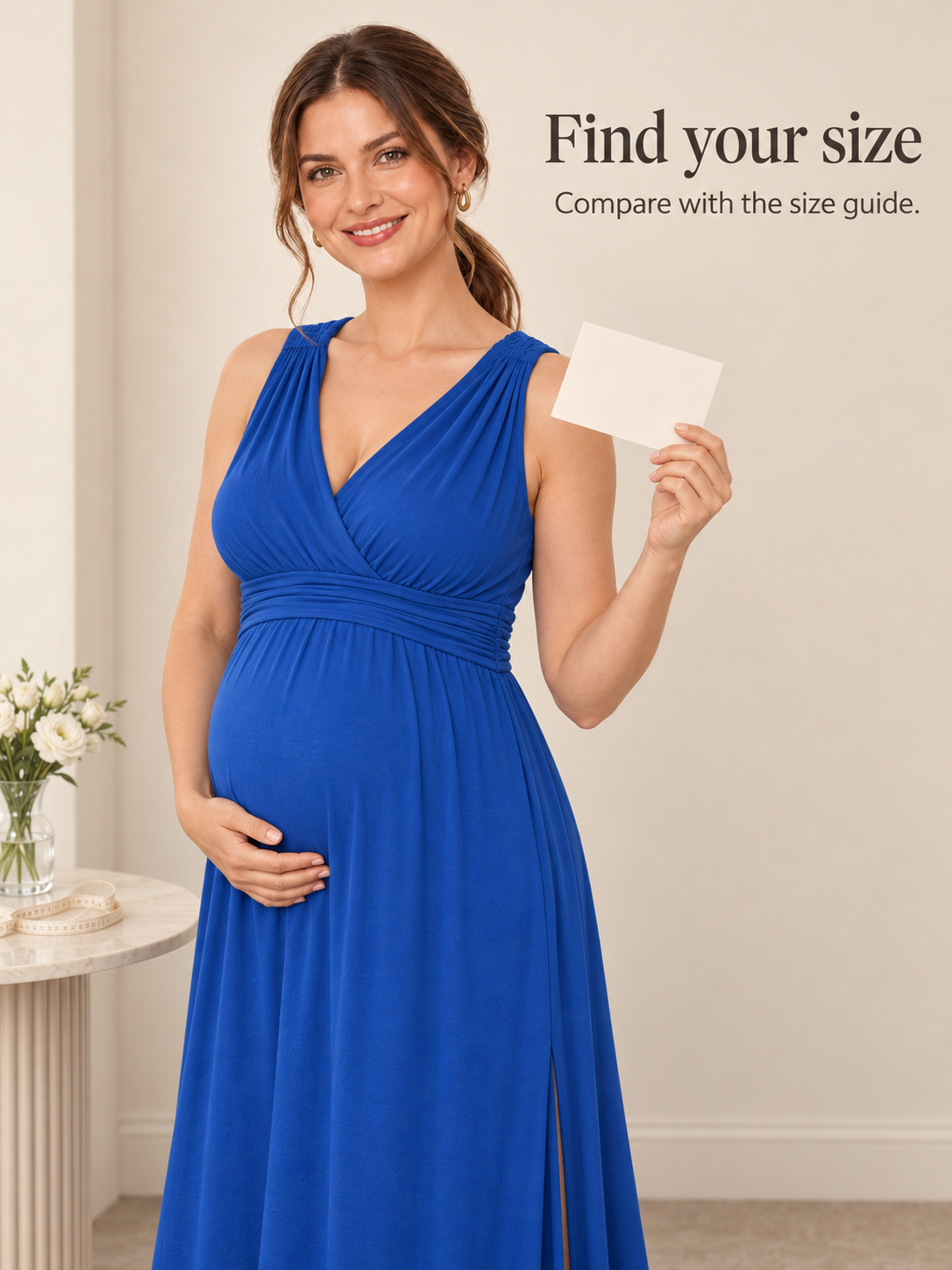 Amara Royal Blue maternity dress — holding a note card in a softly lit studio