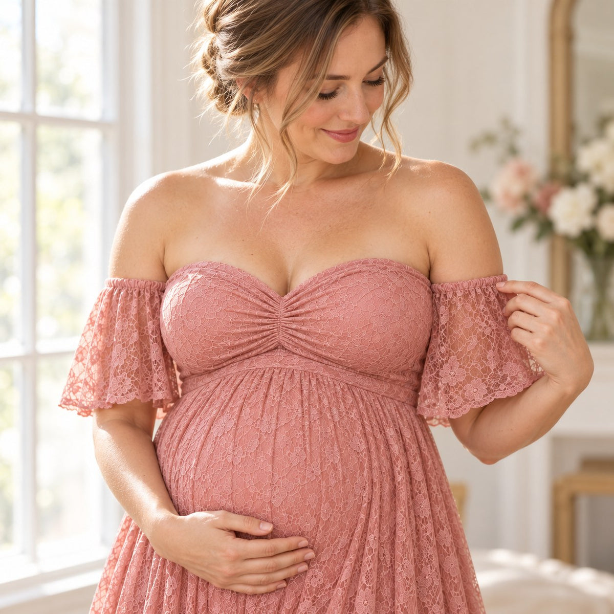 Close-up of the blush pink floral lace bodice with its small center knot and flutter sleeves