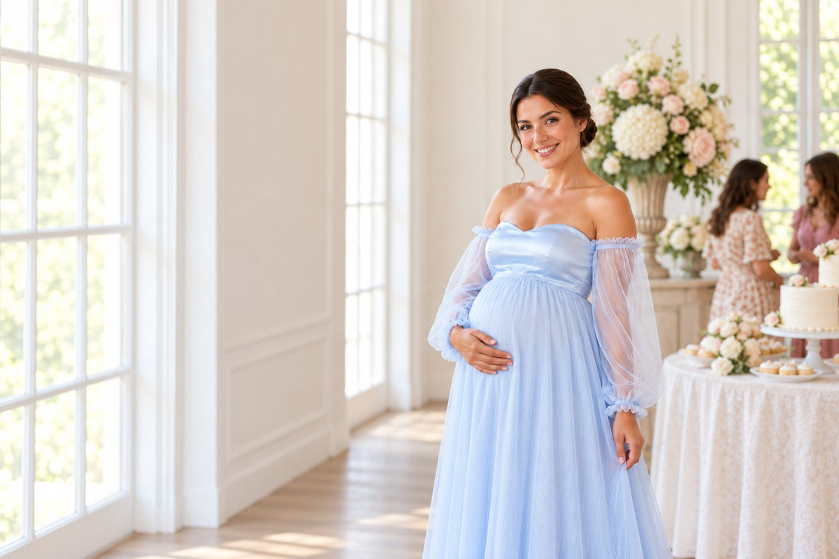 Smiling mom-to-be in a sky blue off-shoulder maternity gown at a bright baby shower with flowers