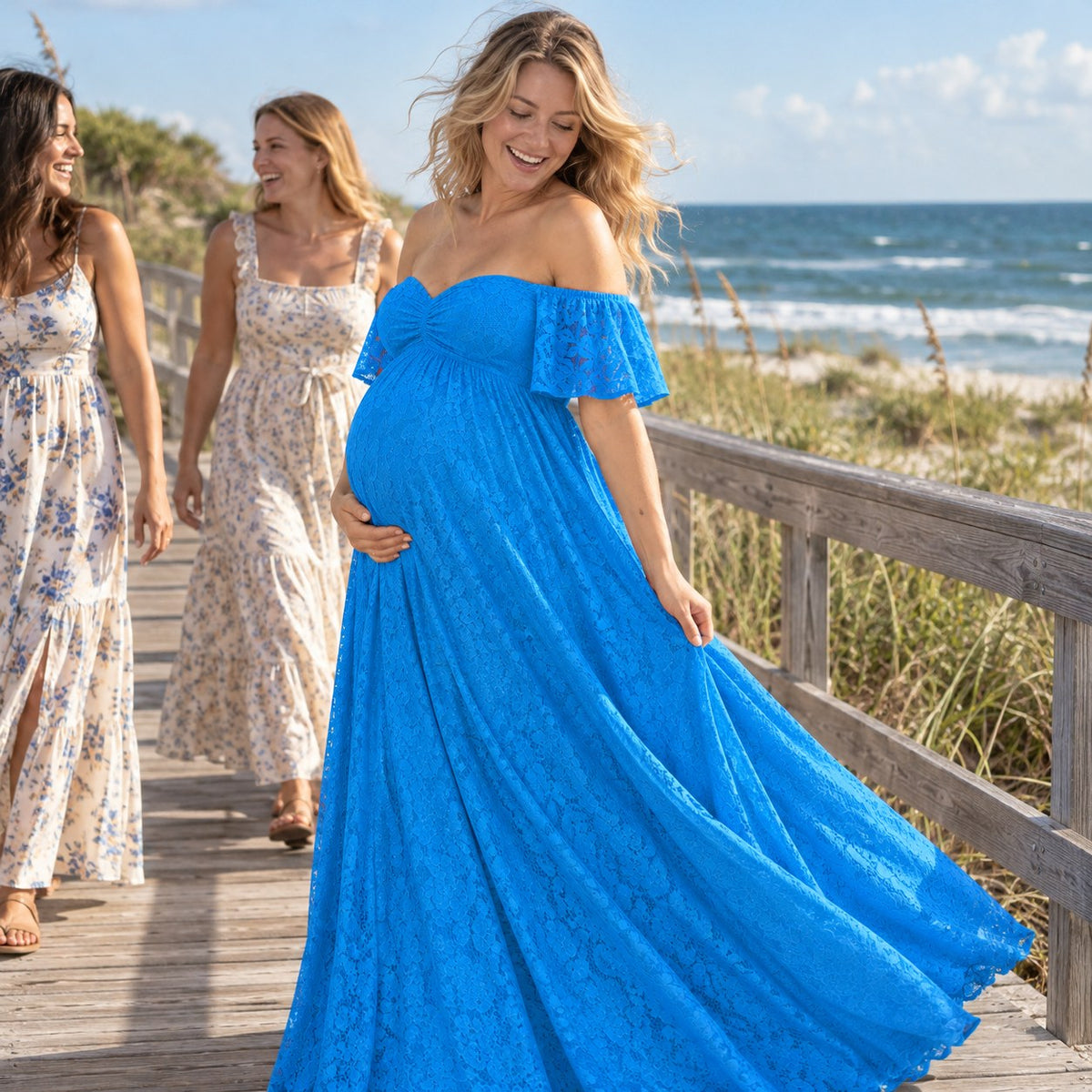 Mom-to-be in an aqua blue lace dress on a beach boardwalk on a breezy afternoon