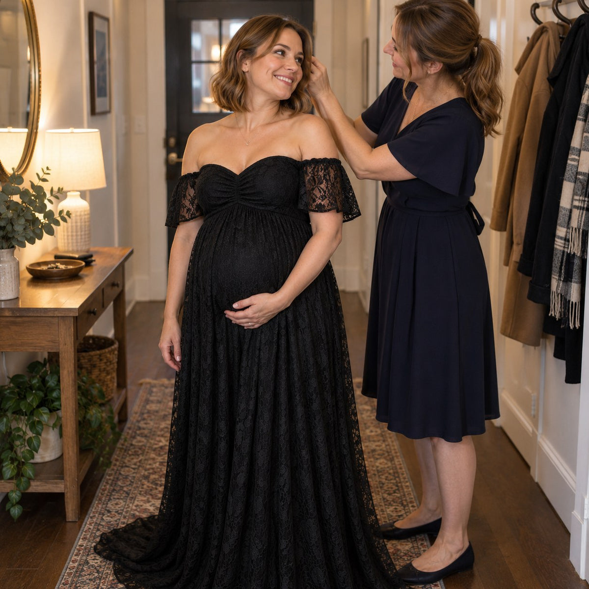 Her sister fixing her hair before a party, in a black lace maternity dress