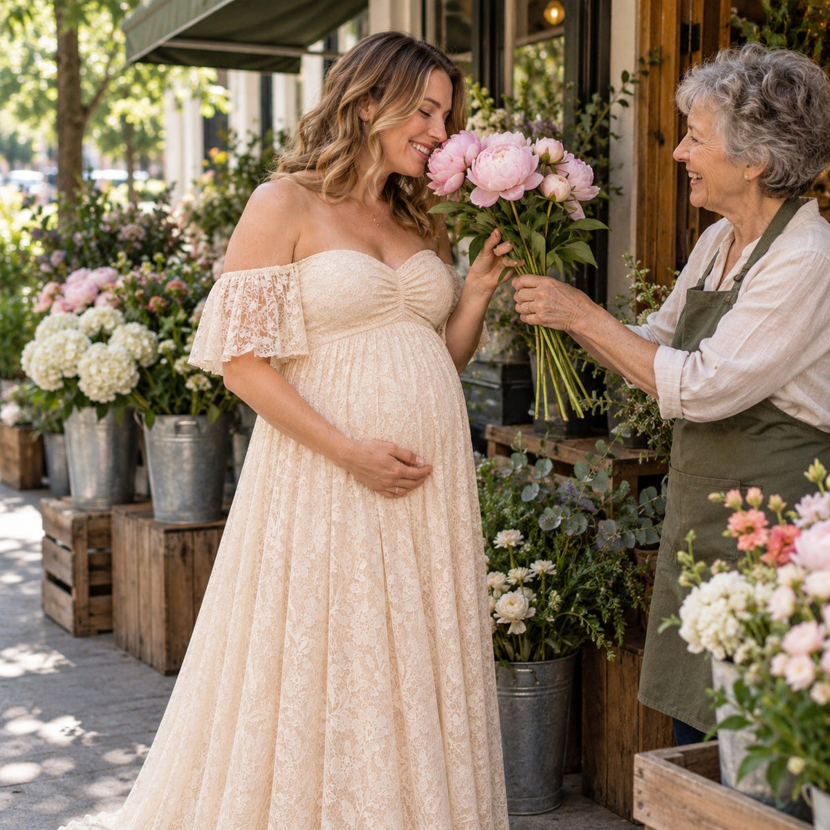 Mom-to-be in a pale apricot lace maternity dress smelling peonies from the florist at a neighborhood flower shop