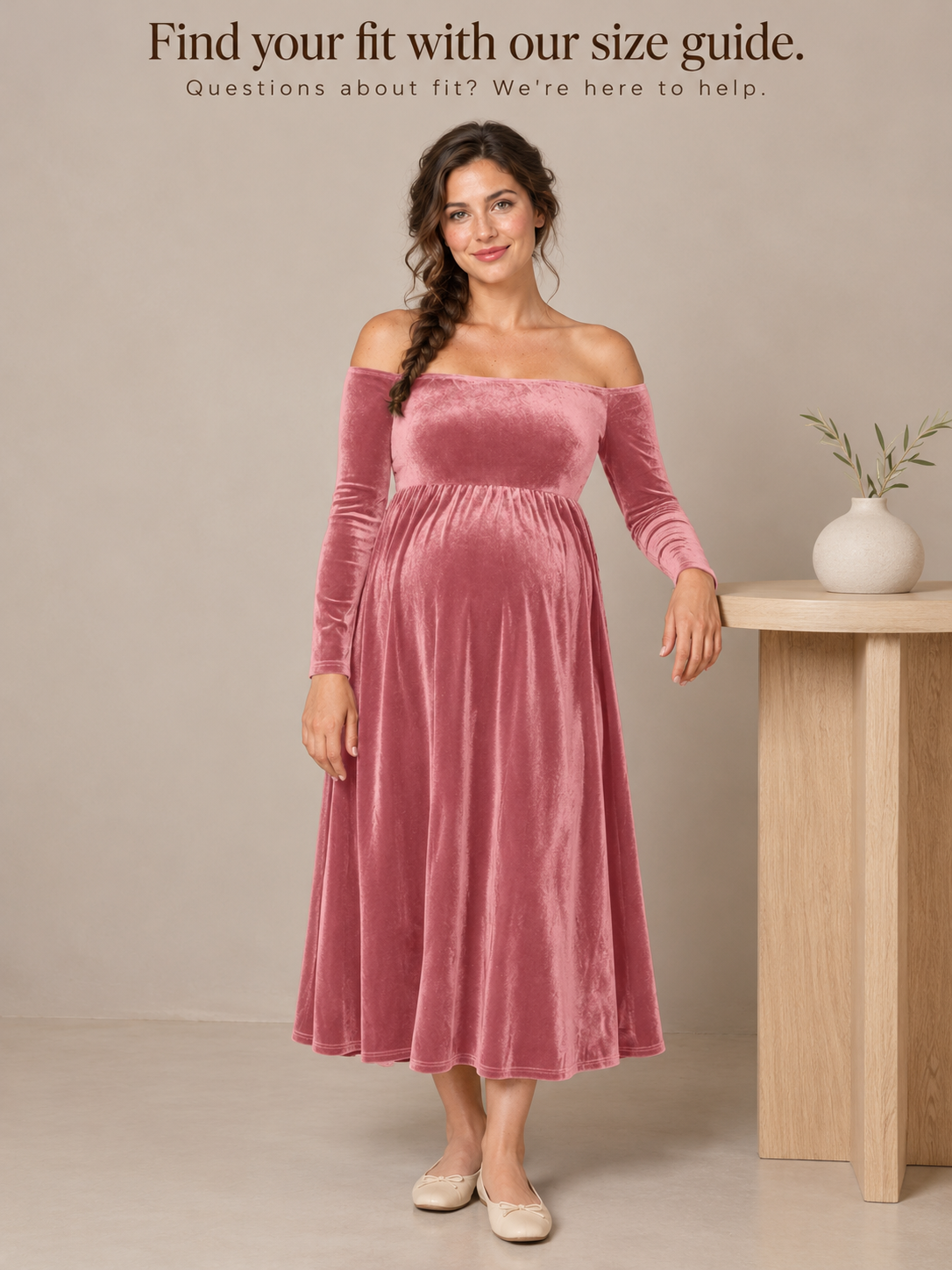 Colette Dusty Rose maternity dress — standing beside a small side table in a plain studio