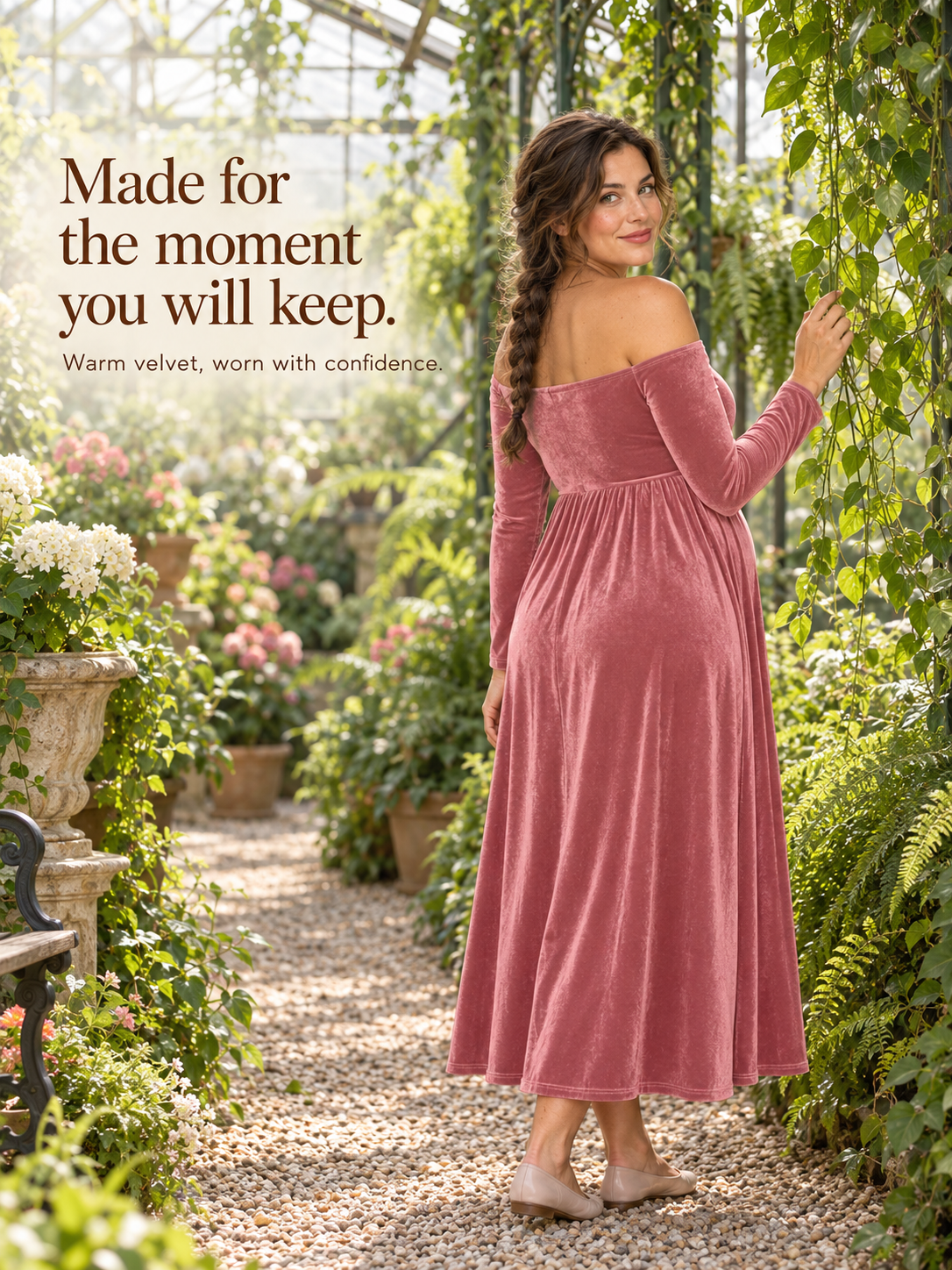 Colette Dusty Rose maternity dress — looking over her shoulder in a flower-filled greenhouse