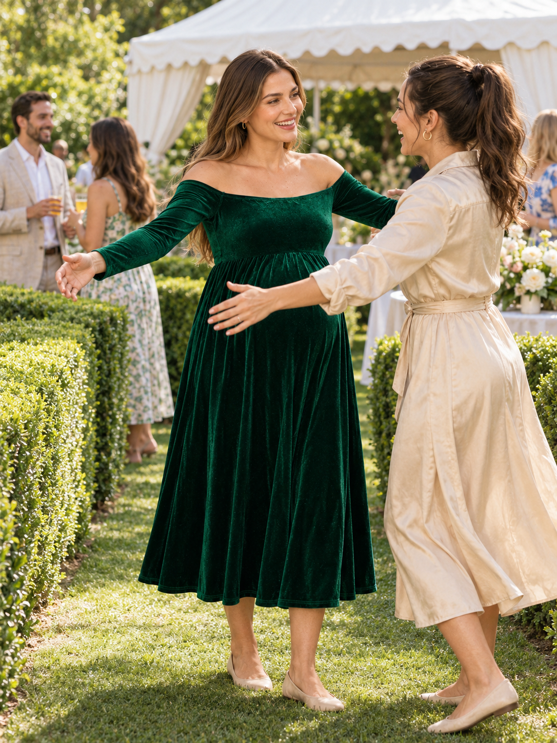 Colette Forest Green maternity dress — greeting a friend with open arms beside a white party tent