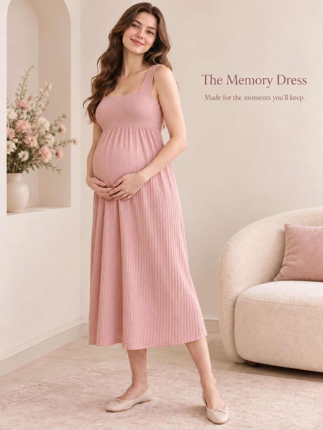 Marcella Blush Pink maternity dress — standing in an arched alcove beside a cream sofa