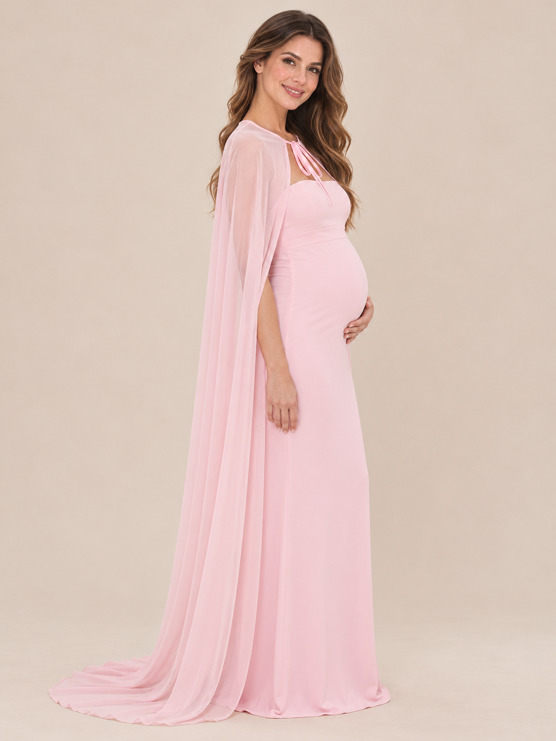 Rosamund Light Pink maternity dress — side view of the fitted silhouette over the bump, with the cape falling behind